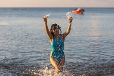 Mutlu seksi kadın, Meksika 'nın Mayalı Rivierası' nın Karayip Denizi 'nin suyunun tadını çıkarıyor. Sıcak güneşin altında, yüzünü ısıtan, elleriyle su sıçratan, keyif almak için ideal tatil yeri..