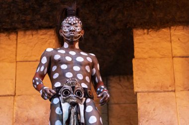 Xcaret, Mexico, January 24, 2023 - Warrior and symbol of the caiman, crocodile or jaguar of the ancient Mayan civilization at Xcaret prepared for the owl dance and fight in the tropical jungle.