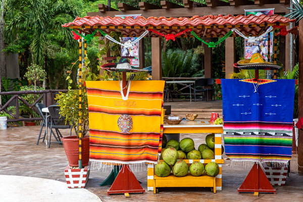 Playa del Carmen, Mexico; April 4, 2023: A Mexican coconut store in Mexico, this is one of the popular street food stands in America, symbolizing Mexico with its hats and other utensils.