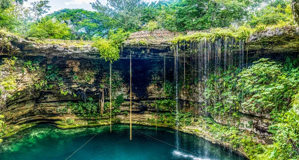 Panoramic view of the water falling from the waterfalls of the subway cenote Saamal of chichen itza is in the Mayan jungle hacienda of the Yucatan Peninsula in Mexico it is an ideal place for vacation
