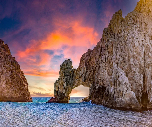 stock image Cape Saint Luke Arch under a beautiful sunset over the Gulf of California that separates the Sea of Cortez from the Pacific Ocean, landscapes of Baja California Sur, Mexico. Rock concept.