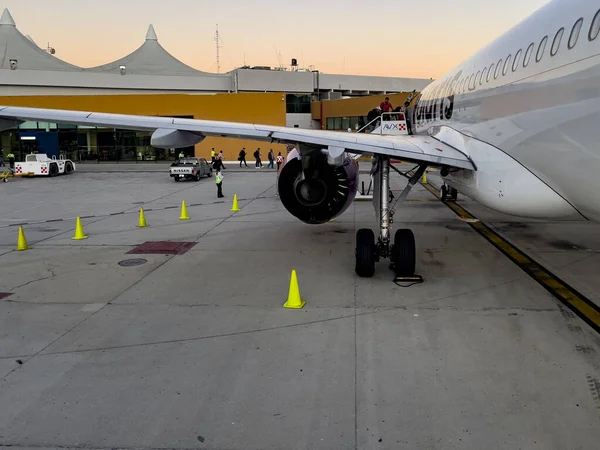 stock image Cabo San Lucas, Mexico, September 5, 2023: People boarding the Volaris Mexican parked plane at Cabo San Lucas International Airport in Mexico's southern Baja California.