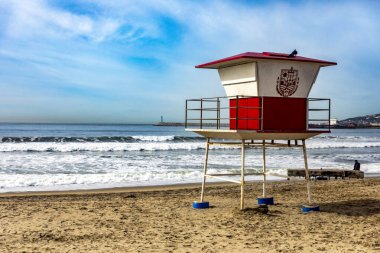 Rosarito, Mexico; September 10, 2023: A guard house of the beach guards on a beautiful beach of Rosarito in Baja California in Mexico, this is a very busy beach visited by tourists under al blue sky. clipart