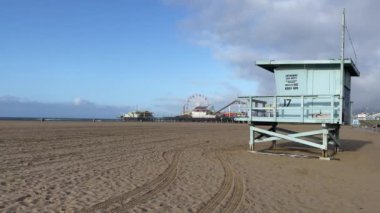 Amerika Birleşik Devletleri 'nin Kaliforniya' daki Santa Monica 'nın ünlü ve güzel beyaz ve altın kumlu kumsalında gün doğumunda cankurtaran kulübesi..