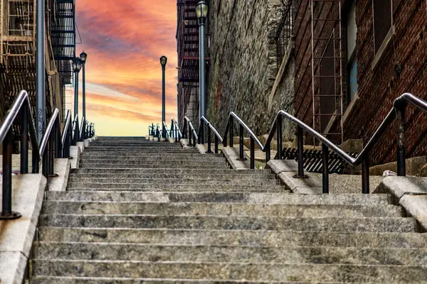 The stairs of the Joker in an orange sunrise or sunset in the famous neighborhood of The Bronx, the famous borough of New York in USA.