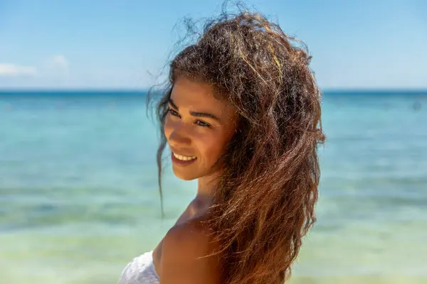 stock image A tropical paradise with a captivating image of a woman brimming with joy in a bikini as she basks in the gentle breeze and sun-drenched shores of a beach paradise.