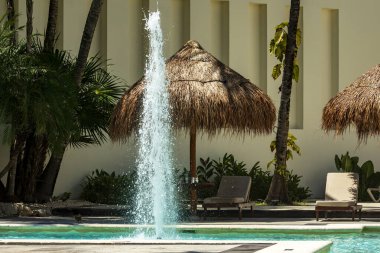 Havuza su fışkırtan çeşme lüks bir tatil köyünü süslüyor, yaz tatilleri ve Karayipler 'de dinlenmek için ideal..