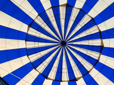 Step inside a world of wonder. This photo captures the serene beauty of a hot air balloon, filled with warm air and ready to take flight. Experience the magic of ballooning. clipart