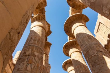 Experience a sense of wonder as you look up at the celestial ceiling created by the intricate carvings on the pillars of Karnak's hypstyle hall. clipart