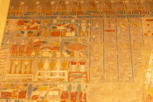 stock image The secrets of ancient Egypt in the intricate hieroglyphs that adorn the walls of Hatshepsut's temple. Each carving tells a unique story, offering insight into the life and reign of the pharaoh.