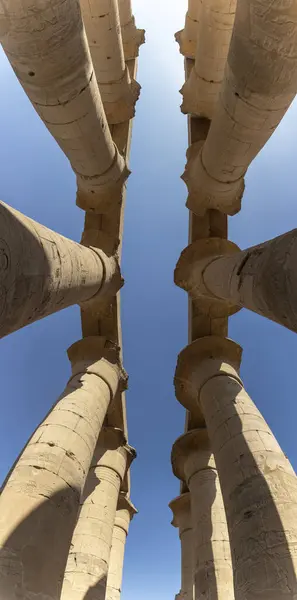 stock image The magical atmosphere of the Temple of Luxor and stroll among the imposing papyrus-shaped columns. The dance of light and shadow on these structures creates an unforgettable visual spectacle.