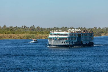 Edfu, Mısır; 17 Ocak 2024: Nil Nehri 'nde bir gemi gezisinde koşuşturma, koşuşturma ve huzur bulmak. Güneş güvertesinde rahatla, antik tapınakları keşfet ve Nil 'in dinginliğinin tadını çıkar..