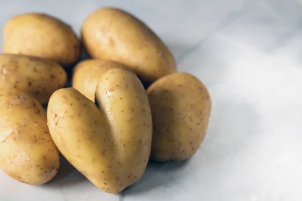 Heart shaped potatoes. A bunch of fresh potatoes. High quality photo