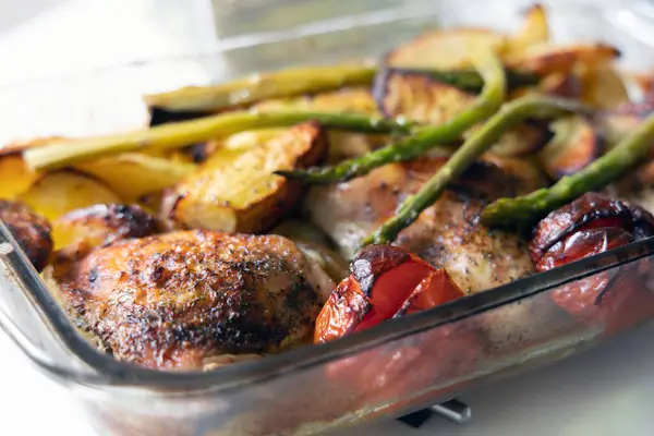 Home cooked food. Fried chicken with potatoes, tomatoes and asparagus. High quality photo