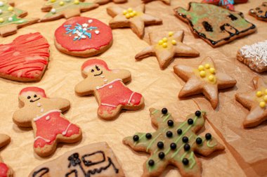 colorful gingerbread cookies in the shape of Santa Clauses, hearts, stars and Christmas trees clipart