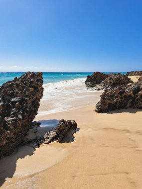 Sakin okyanus dalgaları ve Fuerteventura kayalık kıyıları, kaya labirenti