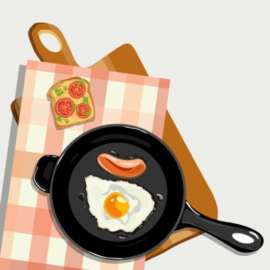 Sosisli sahanda yumurta kesme tahtasının üstünde tava ve domatesli tost ve yeşillikli masa örtüsü. Sağlıklı kahvaltı kavramı