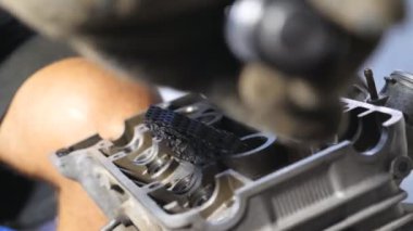 Otomobilden sökülmüş motora bakın. Tanımlanamayan tamirci araba motorunu tamir ediyor. Adam işi için alet kullanıyor. Tamirci garajda ya da atölyede çalışıyor. Yavaş çekim. Yakın çekim..