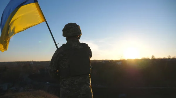 Soldier Ukrainian Army Stands Hill Holds Waving Flag Ukraine Man Stockbild