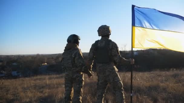 Young Soldiers Camouflage Uniform Stands Waving Ukraine Flag Meadow Sunset — Stock Video