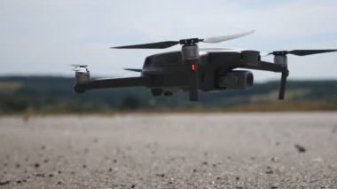 İHA helikopteri kırsaldan kalkıyor. Quadcopter havadan görüntü alıyor ya da manzaranın videosunu kaydediyor. Modern teknoloji kavramı. Yavaşça kapat..