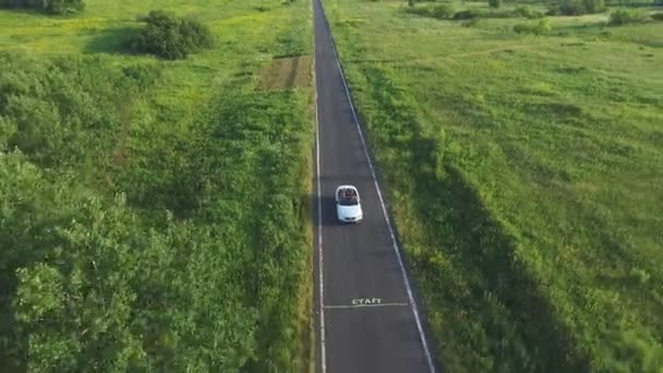 Aerial Shot White Convertible Car Riding Empty Rural Road Four — Stock Video