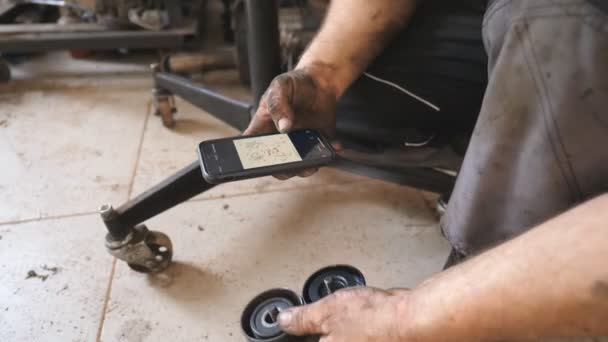 Auto Mechanic Inspecting New Vehicle Part Installation Instruction Smartphone Repairman — Stock Video