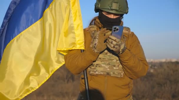 Female Ukrainian Army Soldier Using Smartphone Read News Messaging Family — Vídeo de stock