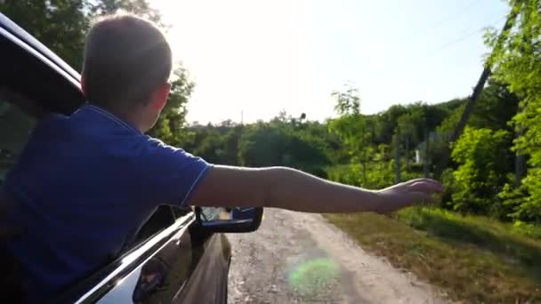 Mały Chłopiec Wychylający Się Przez Okno Wyciągający Rękę Podczas Jazdy — Wideo stockowe