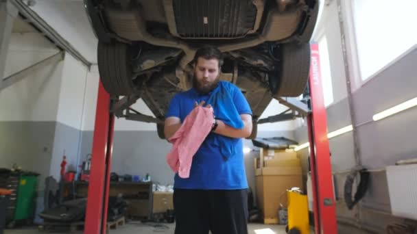 Young Bearded Repairman Wiping His Hands Rag Fuel Oil Hard — Stock Video