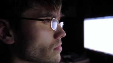 Focused male trader analyzing cryptocurrency market trends on computer screen, showcasing intense concentration and engagement in digital trading environment, capturing the essence of modern finance.