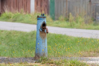Old water column.Rusty water column on a village street.