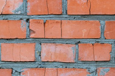 Çatlak bir evin tuğla duvarı. Toprak çöküntüsü, aşınma ve yapı malzemelerinin bozulması. İklim ve mevsimsel değişiklikler..