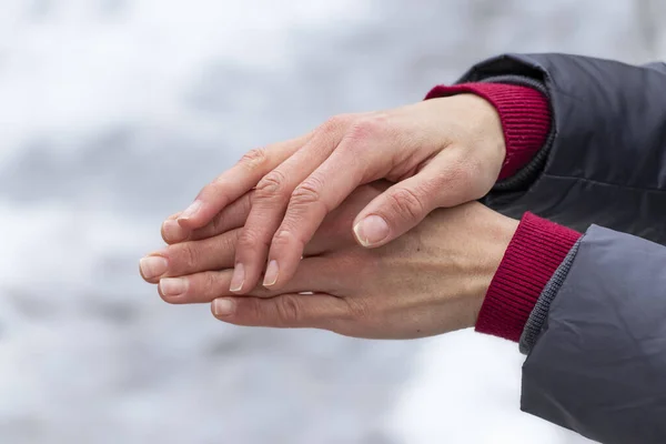 Female hands in the cold in winter. Proper hand care in cold winter.