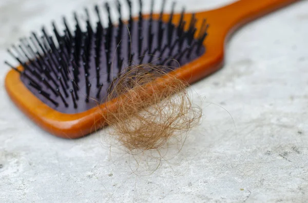 pile of golden brown hair loss concept of healthy hair problems