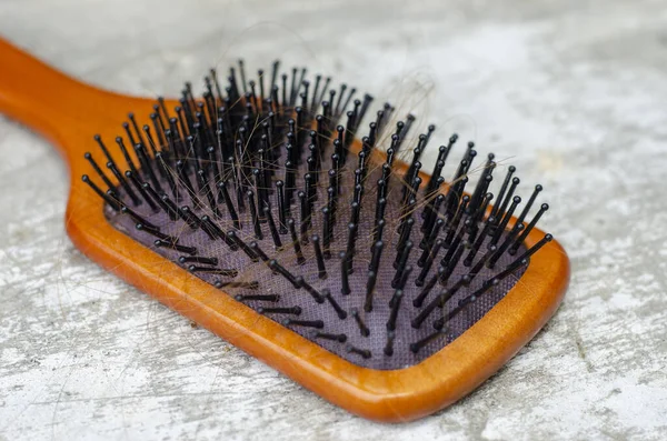 golden brown hair loss problem with hairbrush