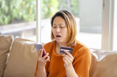 Shocked face of woman, scammer steals money from online transaction clipart