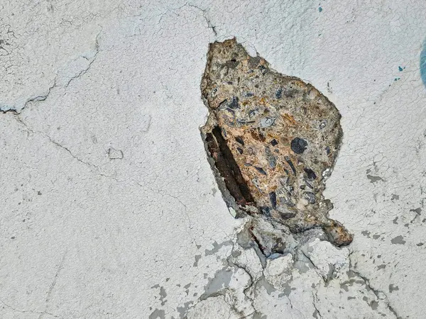 stock image closeup view of a concrete surface with a large, Revealing the steel structure inside