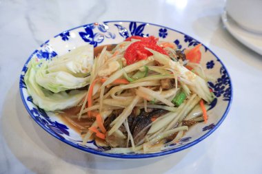 Papaya salad with fermented fish and crab is a popular street Thai food, known for its hot and spicy flavor. This dish, also known as Thai papaya salad, offers a unique and authentic taste experience. clipart