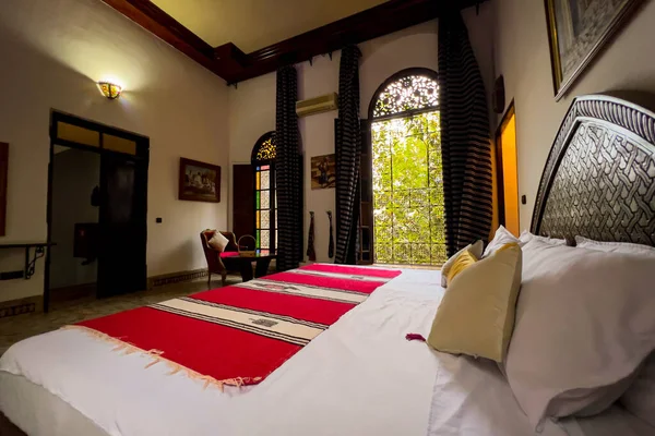 Authentic Moroccan bedroom interior with traditional furnitures in a guest house