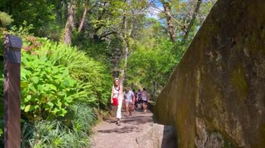 Sintra 'daki Pena Ulusal Sarayı' nın parkında yürüyen turistler