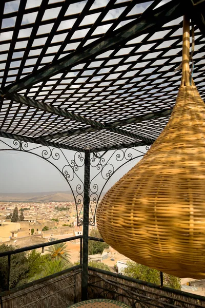 stock image Wicker lamp hanging on the rooftop of a traditional riad with a view over the old medina of Fes