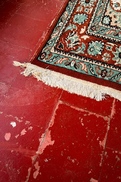 Moroccan carpet on a red painted floor