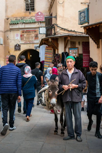 stock image Man standing beside his donkey in the old medina of Fez