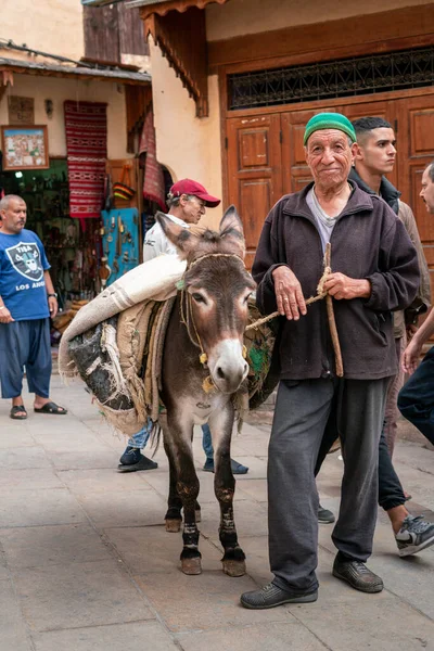 stock image Man standing beside his donkey in the old medina of Fez