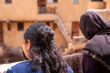 Eski Fez Medina 'daki deri tabakhanesini izleyen iki kadın.