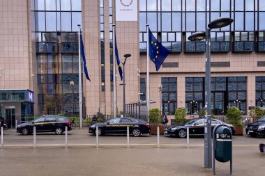 Cars parked next to the headquarters of the European Commission in Bruxelles clipart