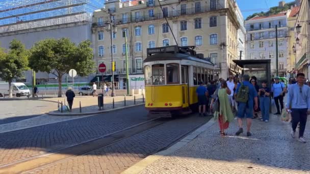 リスボンのプラタ フィゲイラの隣にあるレトロなトラムに乗る乗客 — ストック動画