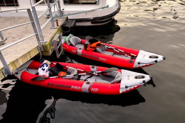 Belçika 'nın Dinant kentindeki Meuse nehrinin kıyısına yanaşmış iki kırmızı şişme tekne.