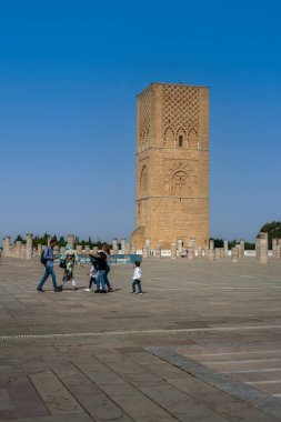 Rabat, Fas 'taki Hasan Kulesi' nin yanındaki ortaçağ sütunlarında yürüyen insanlar.